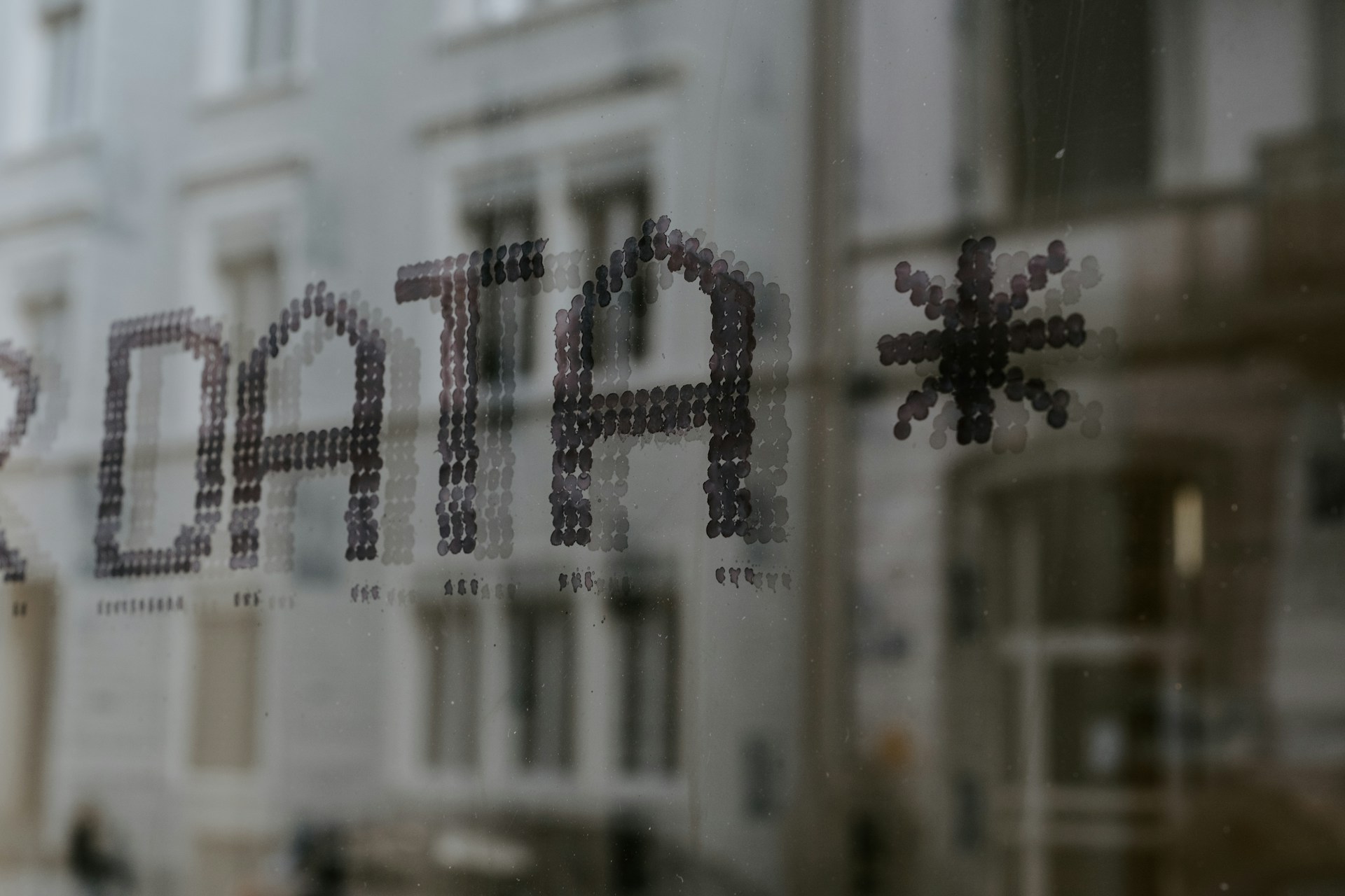 The word Data in a window reflection on a street. Automated data tracking can keep you on the right side of GDPR.