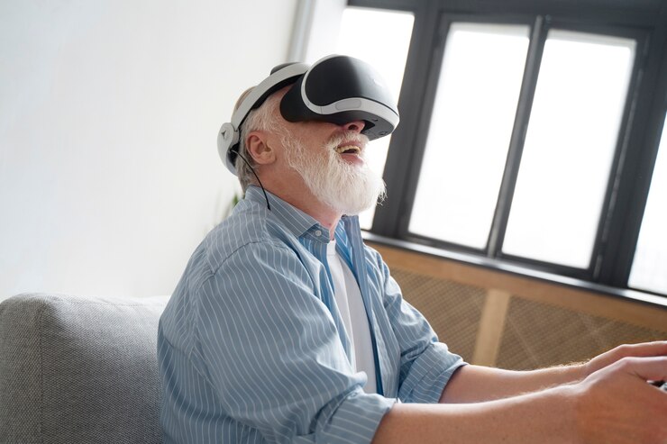 An elderly man in a wheelchair using a virtual reality headset