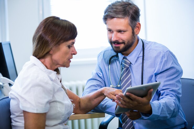 A health professional discussing a care needs assessment with an elderly lady.